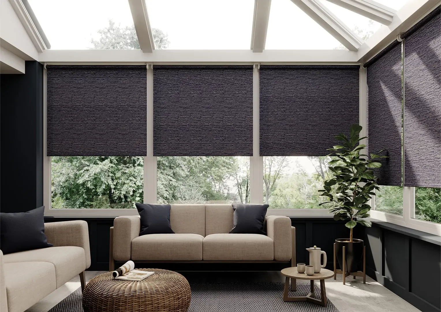 Dark textured roller blinds pulled halfway down across a conservatory, above a cream sofa